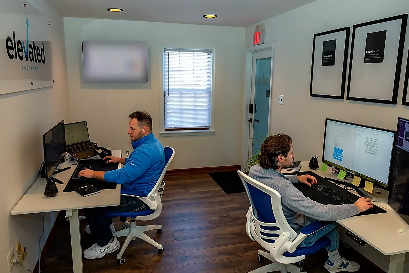 Team members at work in the Elevated Audience office